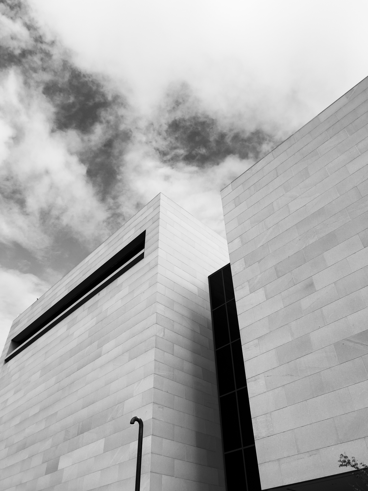 Grayscale brick buildings with cloudy sky Grayscale brick buildings with cloudy sky